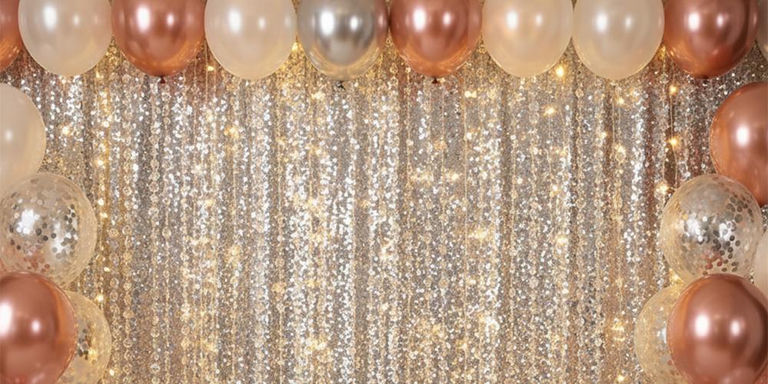 Rose gold balloon garland framing a sparkling sequin party backdrop