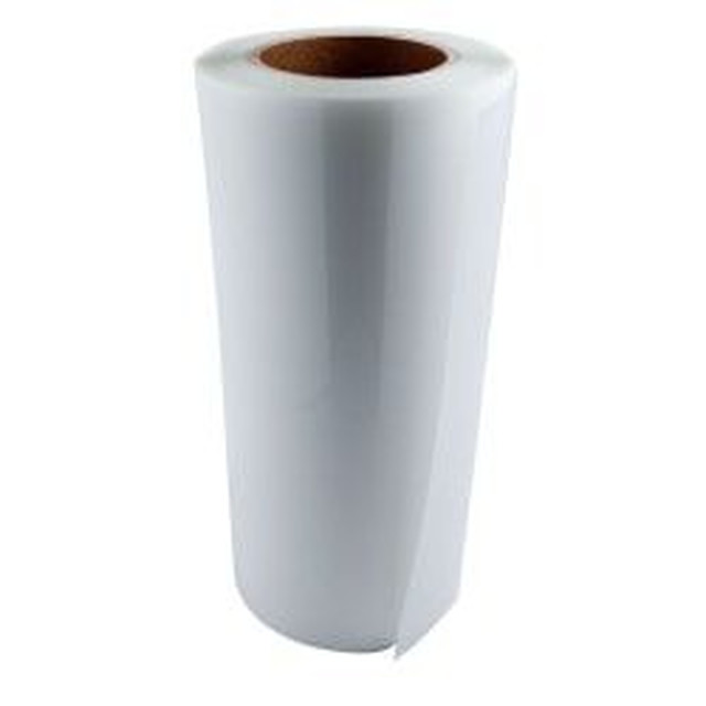 White roll of decal material with a smooth texture and a brown cardboard core partially unrolled at the edge.