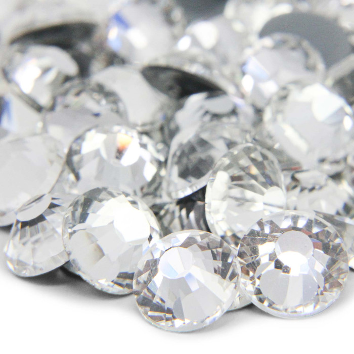 Machine cut crystal rhinestones in clear faceted round shape with a smooth surface and reflective quality. Machine cut crystal rhinestones in clear faceted round shape with a smooth surface and reflective quality.