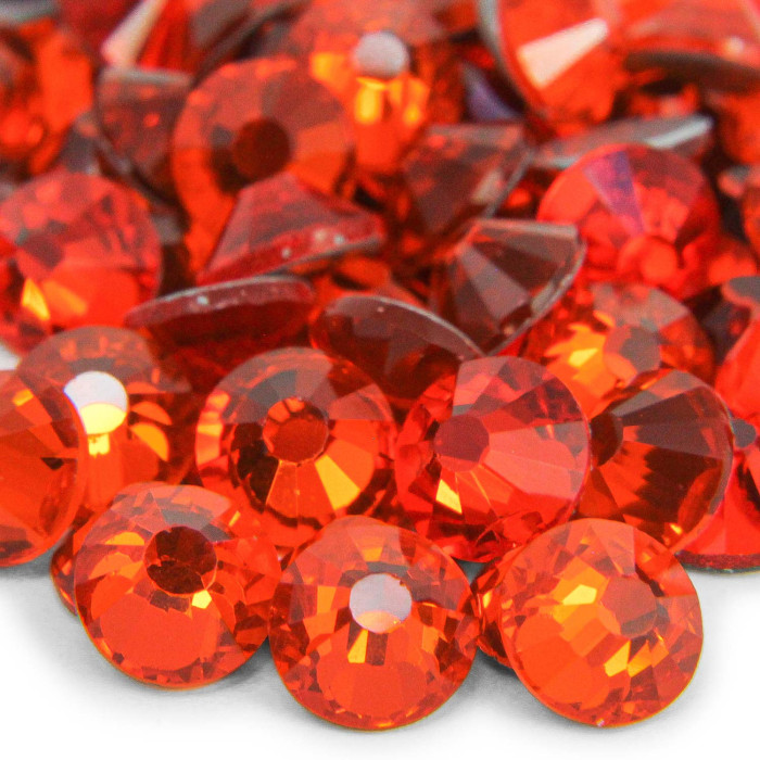 Machine cut crystal rhinestones in vibrant red featuring a faceted round shape and smooth conical backs glossy finish.