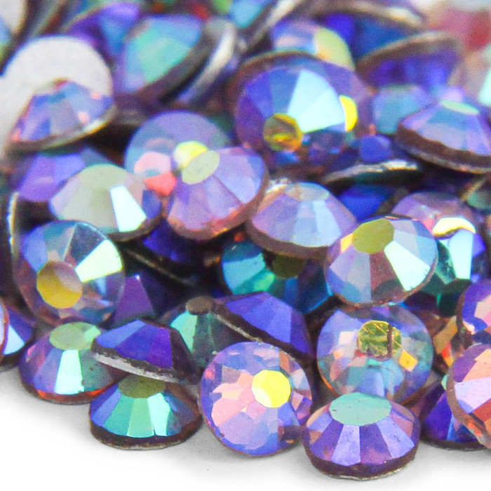 Flatback rhinestones with 12-16 facets light amethyst hue iridescent finish silver metal backing various sizes visible.