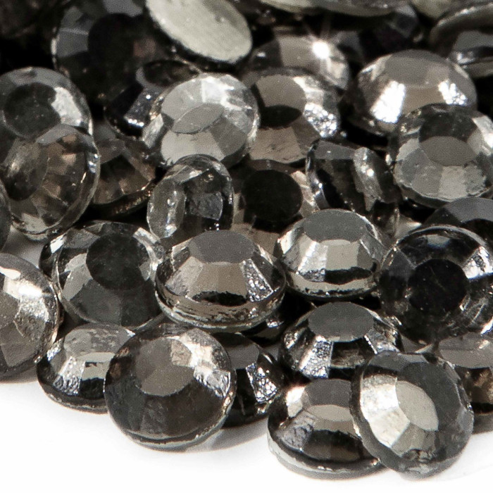 Machine-cut crystal rhinestones in gray with faceted surfaces featuring a smooth shiny texture and a flat back.
