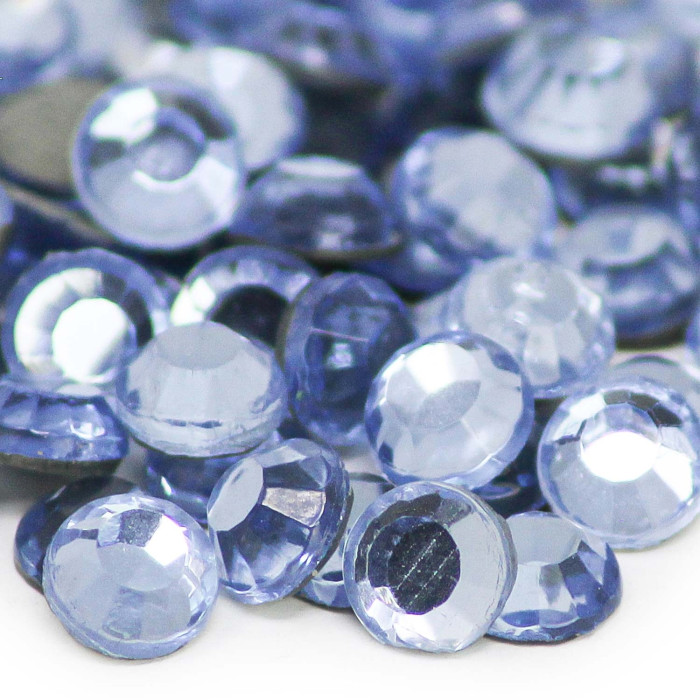 Machine-cut crystal rhinestones in light sapphire blue round shape faceted surface gray glue backing glossy finish.