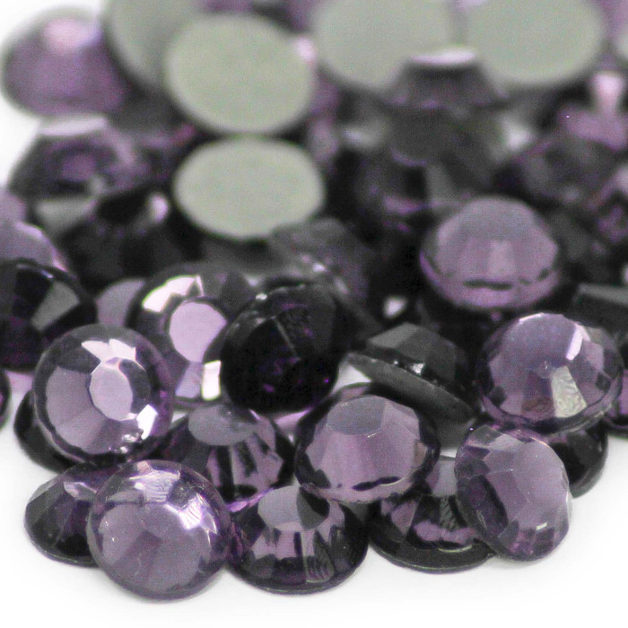 Faceted round crystal rhinestones in shades of purple with a smooth surface and gray glue backing.