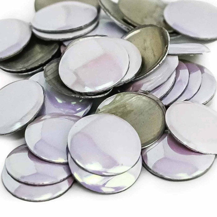 Flat round metal nailheads in iridescent purple and silver with a shiny surface and metallic edges arranged in a scattered pile.