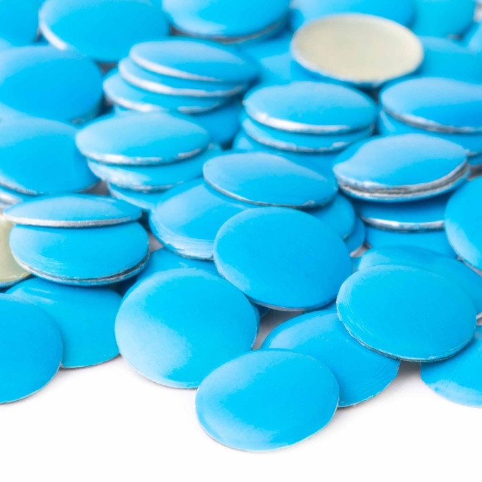 Neon blue circular metal nailheads with a glossy finish and silver backing scattered in a random arrangement.
