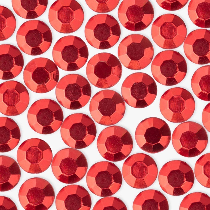 Red machine-cut crystal rhinestones with a faceted surface featuring a shiny finish and gray glue backing.