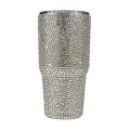 Rhinestone-encrusted double-walled stainless steel tumbler with a clear straw featuring a shimmering iridescent finish.