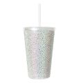 A pink acrylic tumbler covered in rhinestones featuring a silver lid and straw with a textured sparkling surface. A pink acrylic tumbler covered in rhinestones featuring a silver lid and straw with a textured sparkling surface.