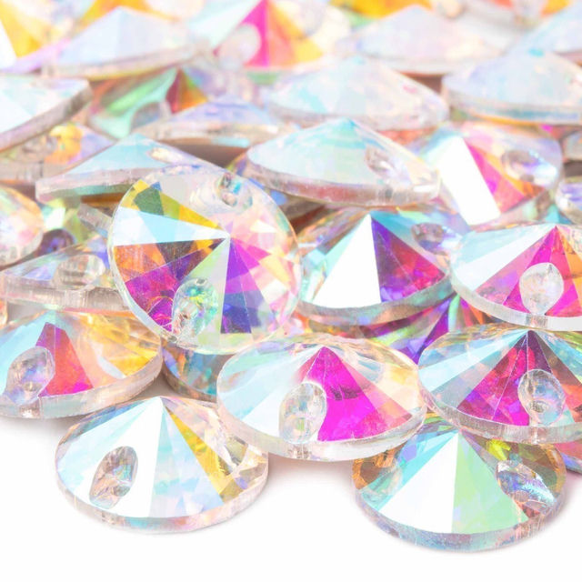 Acrylic rhinestones in clear with rainbow iridescence faceted round shape featuring holes for sewing.