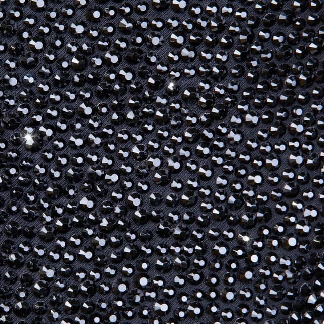 Black blazer covered in shimmering black rhinestones featuring a satin black lapel and two buttons on the front.