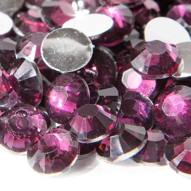 Faceted amethyst resin stones in deep purple with silver backing showcasing sparkle and varying sizes some circular and some round.