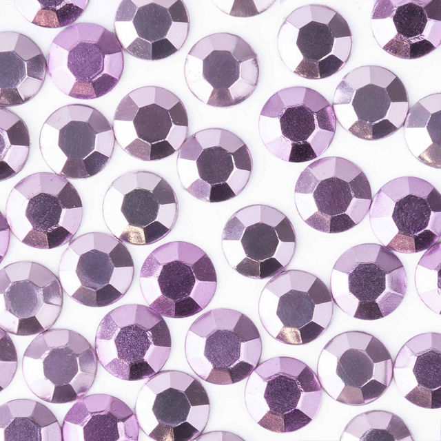 Light purple machine-cut crystal rhinestones with a faceted surface and gray glue backing varying in size and sheen.