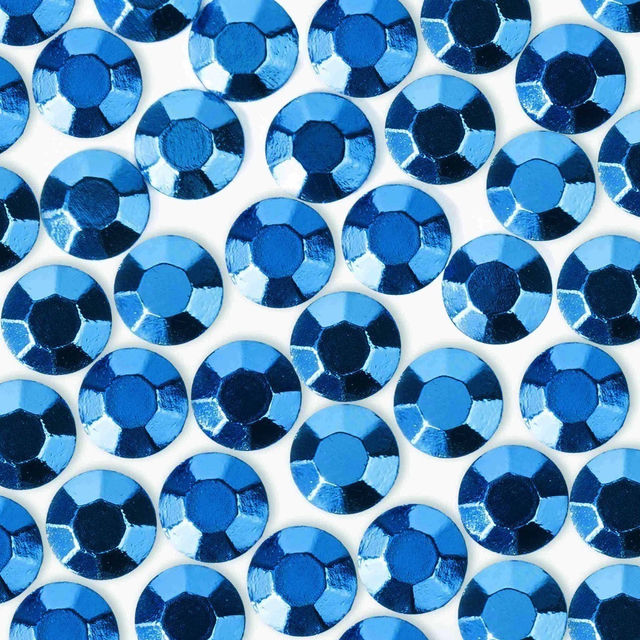 Medium blue crystal rhinestones with a faceted surface circular shape and glossy finish arranged closely together.