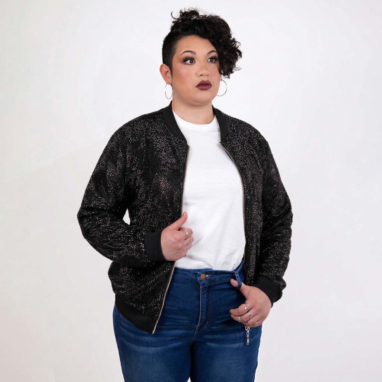 Woman wearing a black strass rhinestone bomber jacket over a white shirt