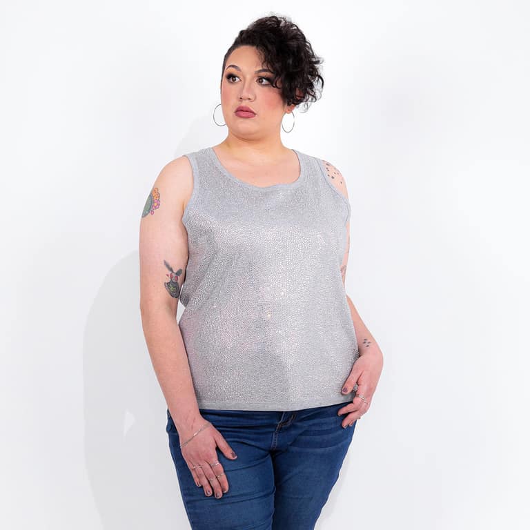 Silver tank top covered in glass rhinestones with a straight fit and a contrasting gray neckline worn with jeans