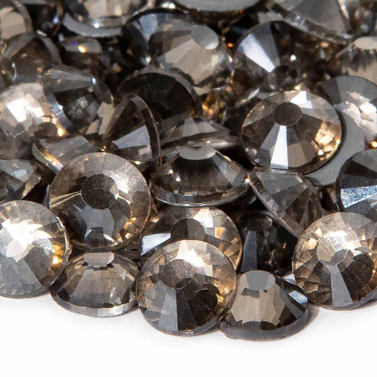 Machine cut crystal rhinestones in light black diamond round shape faceted surface with gray glue backing.