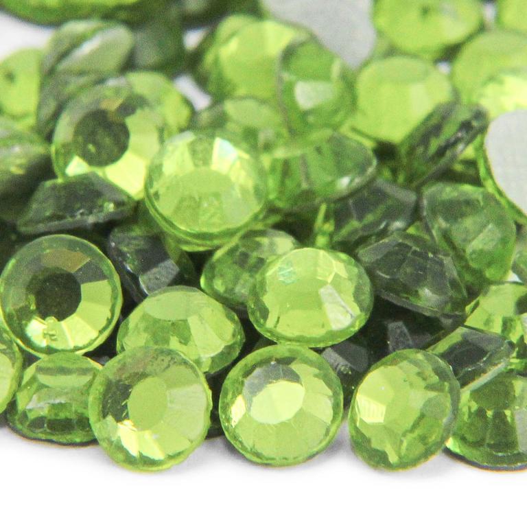 A pile of round faceted glass stones in bright peridot green with a shiny surface and flat silver backing.