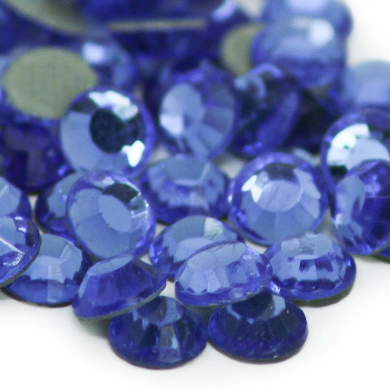 A collection of round faceted glass rhinestones in a deep sapphire blue with a flat backing.