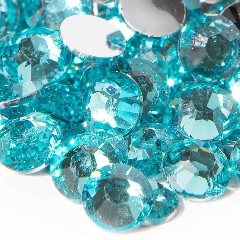 Aqua resin stones with faceted surfaces and silver backing showcasing varying sizes and sparkling clarity.