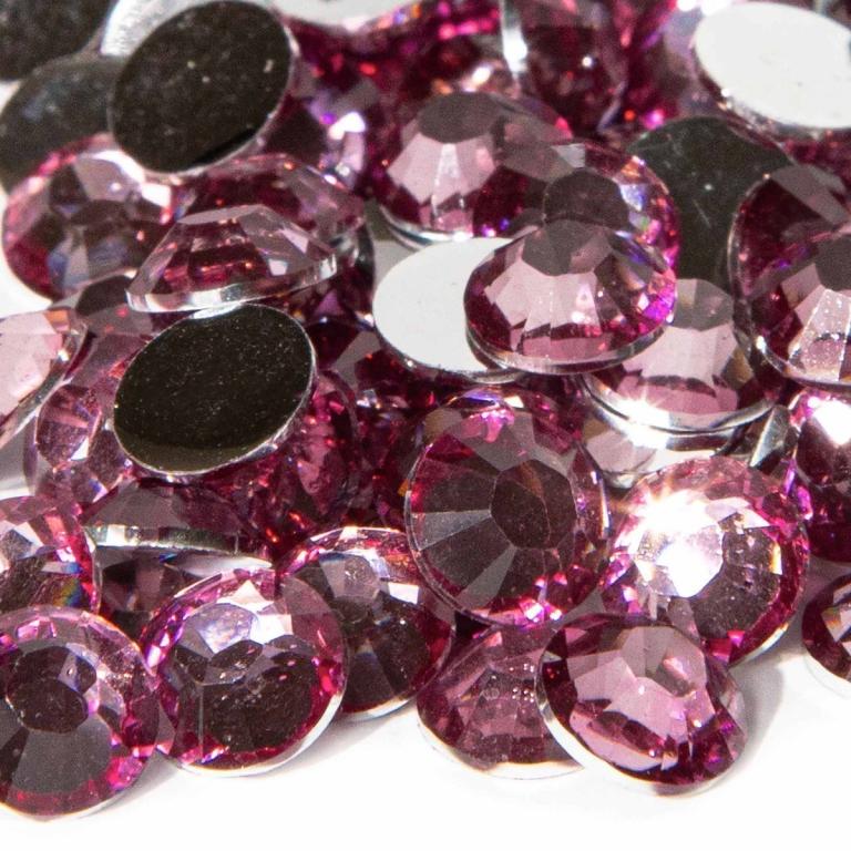 Round faceted resin stones in light amethyst with silver backing displaying varying shades of pink and sparkling reflections.
