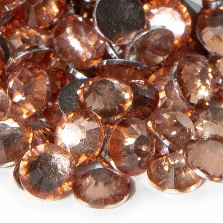 Peach resin stones with faceted surfaces and silver backing displaying a sparkling translucent appearance.