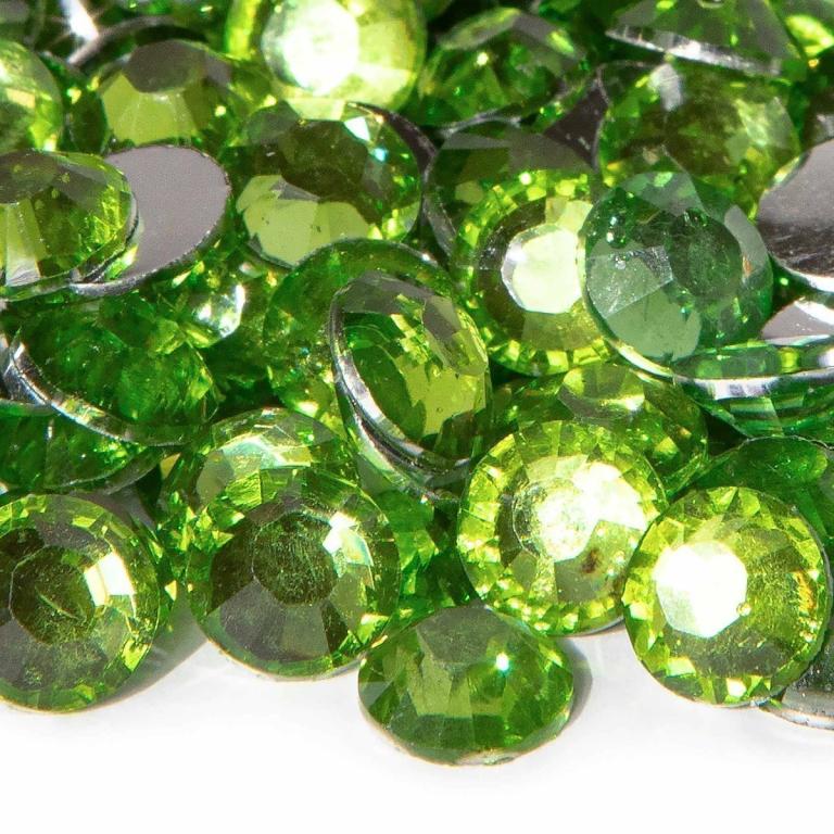 Faceted peridot green resin stones with silver backing varying sizes reflecting light with a sparkling finish.