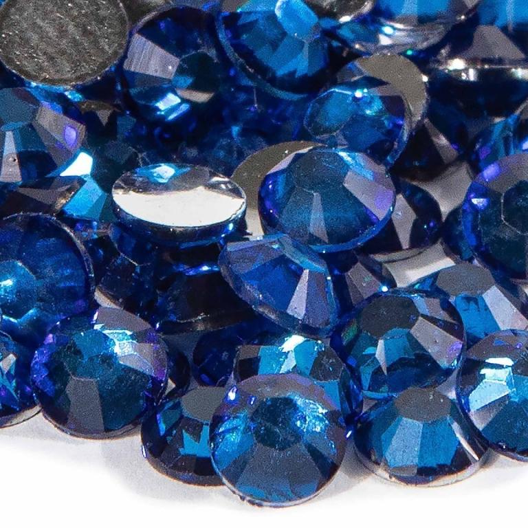 Faceted sapphire blue resin stones with silver backing varying sizes smooth surface and high sparkle effect.