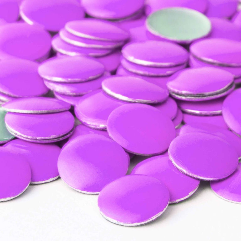 Neon purple flat metal nailheads with shiny surfaces and silver edges arranged in a scattered pattern.