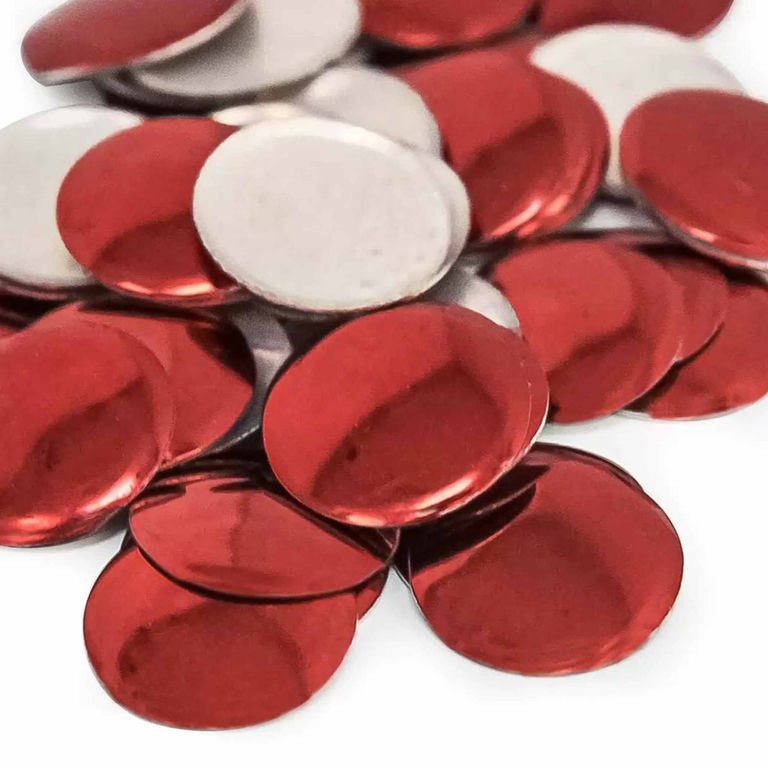 Red metal nailheads with shiny surfaces circular shape and flat backs mixed with some silver-colored pieces.