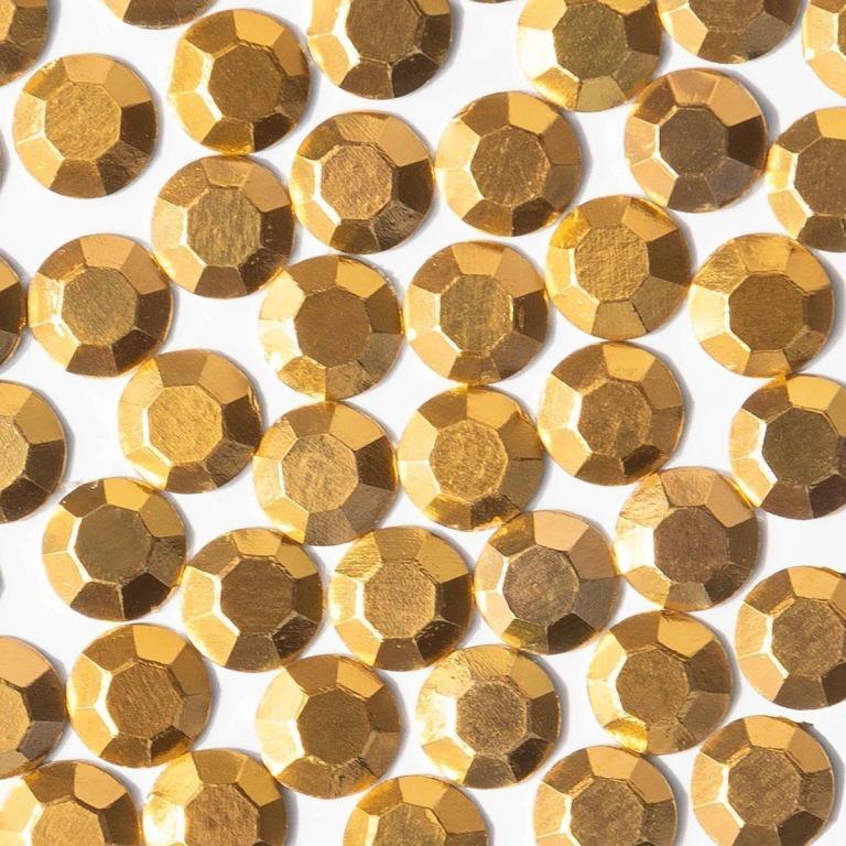 Gold machine-cut crystal rhinestones with faceted surfaces featuring a shiny metallic finish and smooth edges.