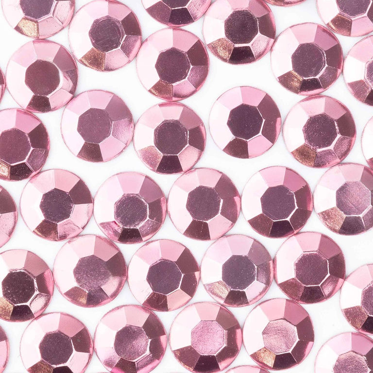 Light pink machine-cut crystal rhinestones with faceted surfaces and a glossy finish arranged closely together.