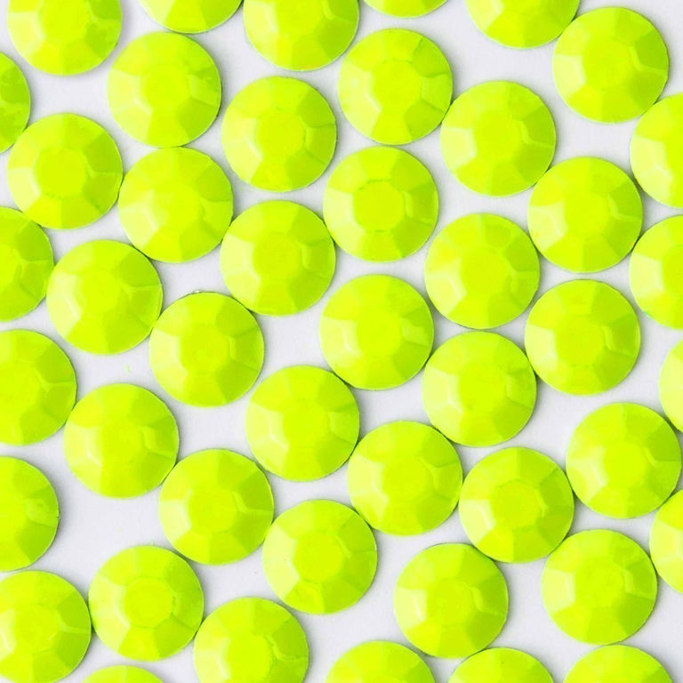 Neon yellow crystal rhinestones with a faceted surface round shape and glossy finish arranged closely together.