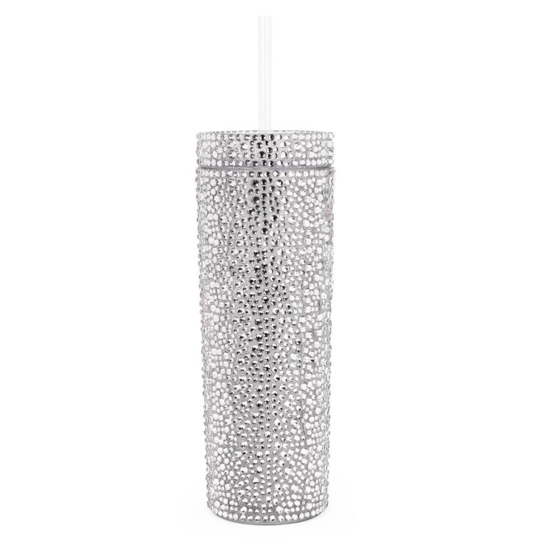 Silver tumbler covered in rhinestones with a clear straw cylindrical shape smooth texture and shiny surface.