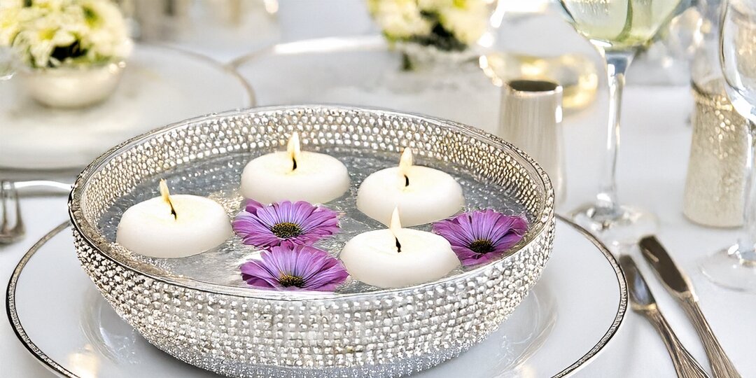 Elegant&amp;&#x23;x20&#x3B;rhinestone-covered&amp;&#x23;x20&#x3B;bowl&amp;&#x23;x20&#x3B;with&amp;&#x23;x20&#x3B;floating&amp;&#x23;x20&#x3B;candles&amp;&#x23;x20&#x3B;and&amp;&#x23;x20&#x3B;purple&amp;&#x23;x20&#x3B;flowers&amp;&#x23;x20&#x3B;on&amp;&#x23;x20&#x3B;a&amp;&#x23;x20&#x3B;formal&amp;&#x23;x20&#x3B;event&amp;&#x23;x20&#x3B;table