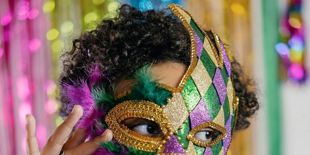 Person&amp;&#x23;x20&#x3B;wearing&amp;&#x23;x20&#x3B;colorful&amp;&#x23;x20&#x3B;Mardi&amp;&#x23;x20&#x3B;Gras&amp;&#x23;x20&#x3B;mask&amp;&#x23;x20&#x3B;with&amp;&#x23;x20&#x3B;glitter&amp;&#x23;x20&#x3B;diamonds&amp;&#x23;x20&#x3B;and&amp;&#x23;x20&#x3B;gold&amp;&#x23;x20&#x3B;trim