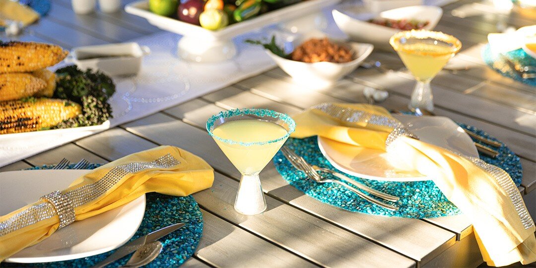 Vibrant&amp;&#x23;x20&#x3B;outdoor&amp;&#x23;x20&#x3B;dining&amp;&#x23;x20&#x3B;table&amp;&#x23;x20&#x3B;with&amp;&#x23;x20&#x3B;bright&amp;&#x23;x20&#x3B;pink&amp;&#x23;x20&#x3B;tablecloth,&amp;&#x23;x20&#x3B;place&amp;&#x23;x20&#x3B;settings&amp;&#x23;x20&#x3B;featuring&amp;&#x23;x20&#x3B;sparkly&amp;&#x23;x20&#x3B;round&amp;&#x23;x20&#x3B;placemats,&amp;&#x23;x20&#x3B;white&amp;&#x23;x20&#x3B;dinnerware,&amp;&#x23;x20&#x3B;yellow&amp;&#x23;x20&#x3B;napkins,&amp;&#x23;x20&#x3B;and&amp;&#x23;x20&#x3B;colorful&amp;&#x23;x20&#x3B;floral&amp;&#x23;x20&#x3B;centerpiece,&amp;&#x23;x20&#x3B;set&amp;&#x23;x20&#x3B;against&amp;&#x23;x20&#x3B;brick&amp;&#x23;x20&#x3B;wall&amp;&#x23;x20&#x3B;garden&amp;&#x23;x20&#x3B;backdrop.
