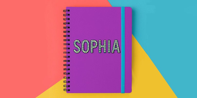 A purple spiral-bound notebook with the name SOPHIA spelled out in multicolor rhinestones, displayed on a vibrant coral, yellow, and turquoise color-blocked background