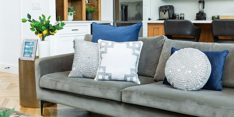Gray sofa navy velvet pillows silver sequined throws