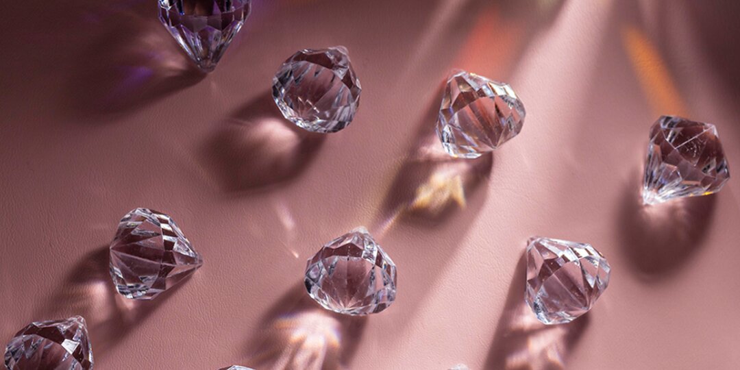 Clear&amp;&#x23;x20&#x3B;crystal&amp;&#x23;x20&#x3B;rhinestones&amp;&#x23;x20&#x3B;catching&amp;&#x23;x20&#x3B;light&amp;&#x23;x20&#x3B;on&amp;&#x23;x20&#x3B;a&amp;&#x23;x20&#x3B;pink&amp;&#x23;x20&#x3B;background