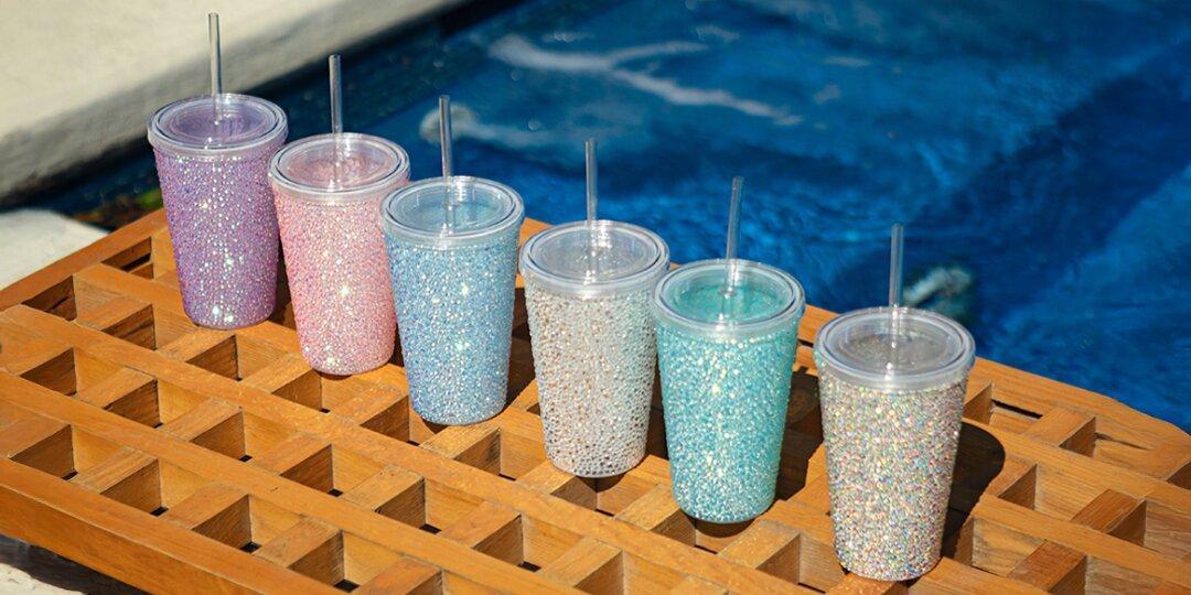 Colorful&amp;&#x23;x20&#x3B;rhinestone&amp;&#x23;x20&#x3B;glam&amp;&#x23;x20&#x3B;tumblers&amp;&#x23;x20&#x3B;with&amp;&#x23;x20&#x3B;straws&amp;&#x23;x20&#x3B;lined&amp;&#x23;x20&#x3B;up&amp;&#x23;x20&#x3B;on&amp;&#x23;x20&#x3B;pool&amp;&#x23;x20&#x3B;deck
