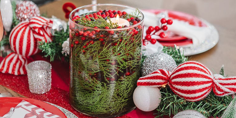 close-up of peppermint ornament centerpiece with floating candle in glass hurricane