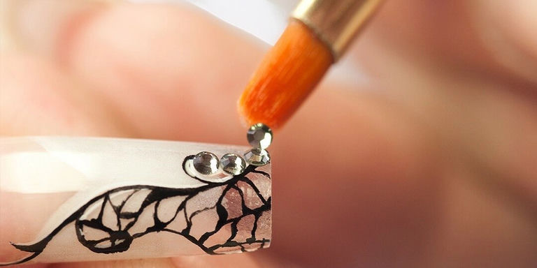 Applying rhinestones to nails with a brush