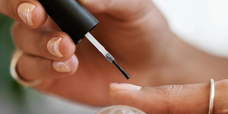 Applying adhesive for rhinestones on nails