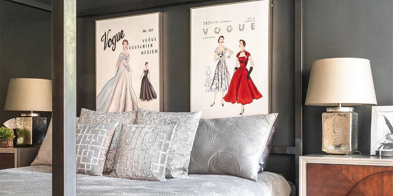 vintage Vogue fashion art prints above a stylish glam bedroom bed setup