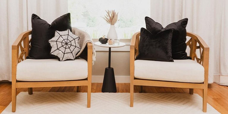 velvet and rhinestone pillows styled on wood armchairs in reading nook