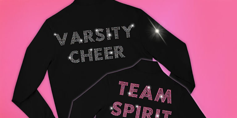 Varsity jackets on pink background with TEAM SPIRIT and VARSITY CHEER spelled out in rhinestones