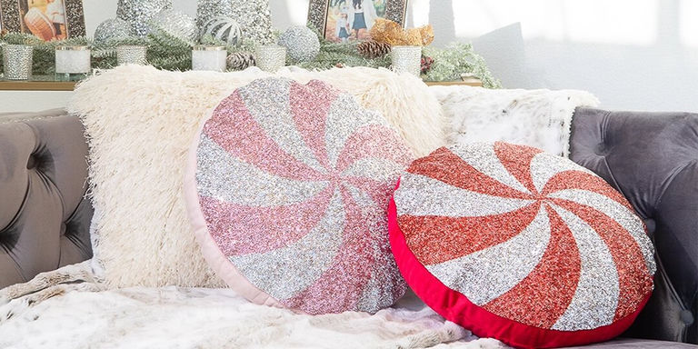 pink and red peppermint swirl holiday pillows with rhinestones styled on glam faux fur sofa