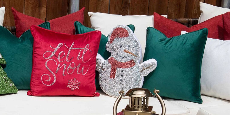 silver glitter snowman holiday pillow paired with red Let It Snow cushion and emerald green pillows
